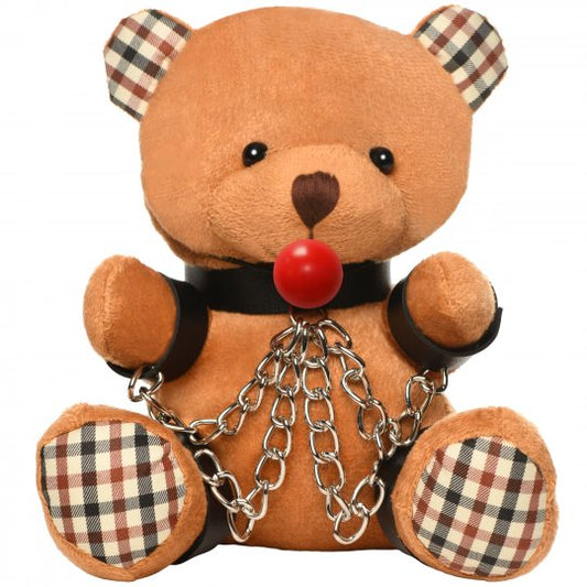 Gagged teddy bear with wrist and ankle cuffs, nickel-free chains, and a ball gag, designed for playfulness and aftercare, measuring 8.6 inches long and made from polyester and PU faux leather, in brown color.