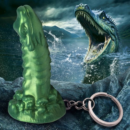 A whimsical green keychain shaped like a dragon-like creature inspired by the Loch Ness monster, made of premium silicone and nickel-free metal, featuring textured details and a curved design, perfect for adding a touch of fantasy flair to bags or keys.