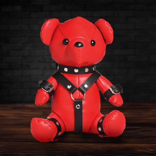 A red teddy bear dressed in a detailed gimp outfit made of high-quality vegan leather, showcasing a playful and edgy design, perfect for adding a kinky touch to any collection.