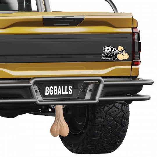 Image of extra-large Big Truck Nuts hanging from a trailer hitch, showcasing their humorous design with a light color and wrinkled texture, ideal for gag gifts at parties and events.