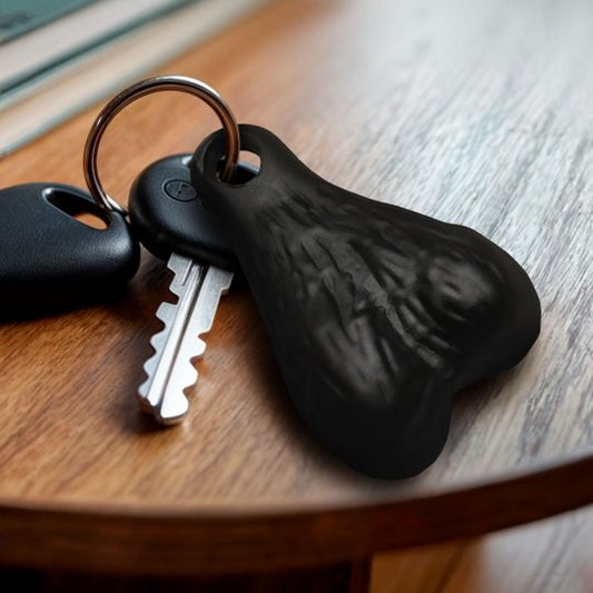 A humorous keychain featuring large plastic nuts hanging from a nickel-free metal ring, showcasing a playful design suitable for gifts and party favors.