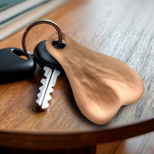 A humorous keychain featuring large plastic nuts attached to a nickel-free metal ring, ideal for showcasing a playful personality and preventing lost keys.