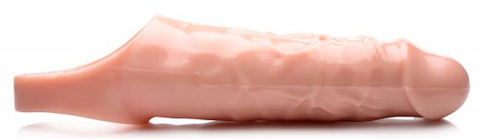 Flesh-colored erection enhancer made of stretchy TPR material, featuring a hollow shaft with sensation bumps, a ring for testicles, and dimensions of 6.5 inches insertable length and 2 inches diameter, on a white background.