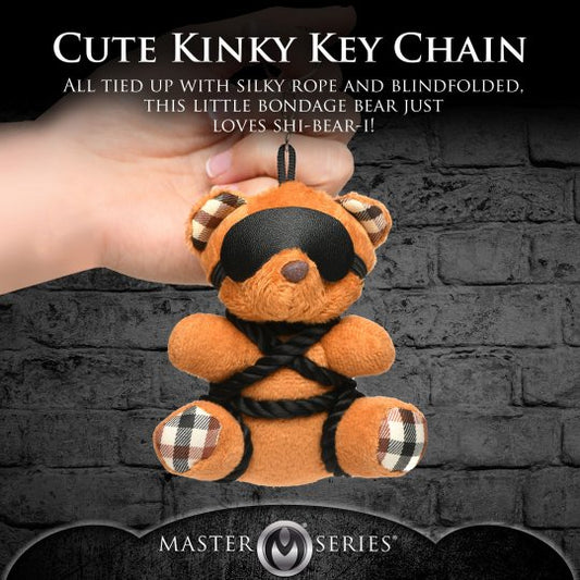 Kinky bondage bear keychain in brown, featuring silky rope ties and a removable PU leather blindfold, ideal as a novelty gift and office desk accessory.